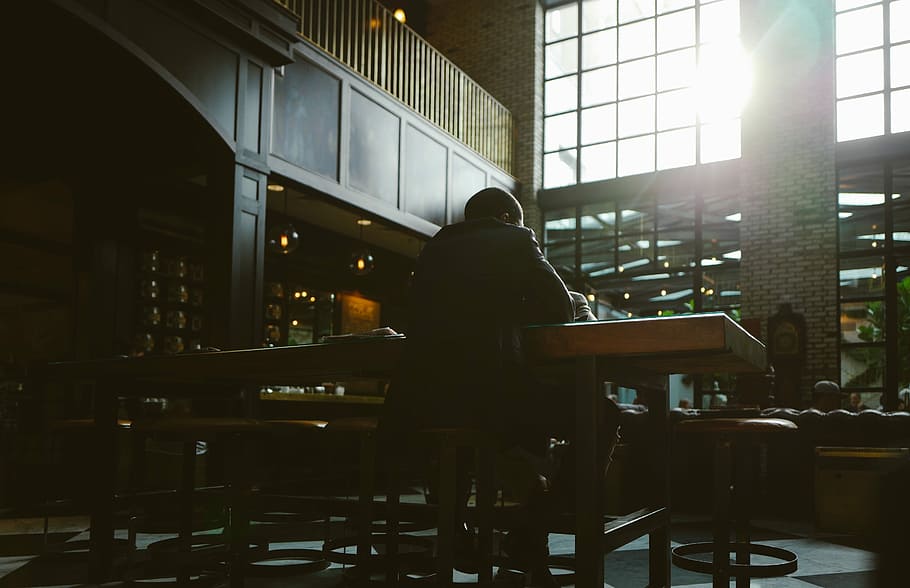 man sitting on chair in facing back in front of table, people HD wallpaper