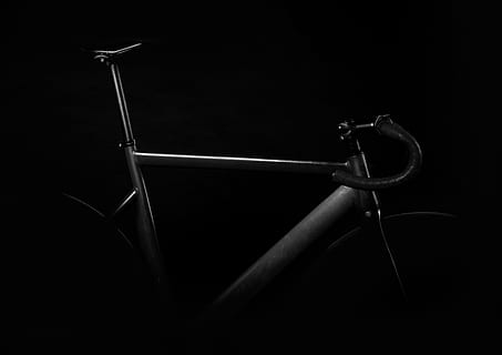 black road bike on against black background, gray triathlon bicycle in dark room HD wallpaper