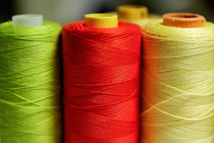 green, red, and yellow threads in shallow focus photography HD wallpaper