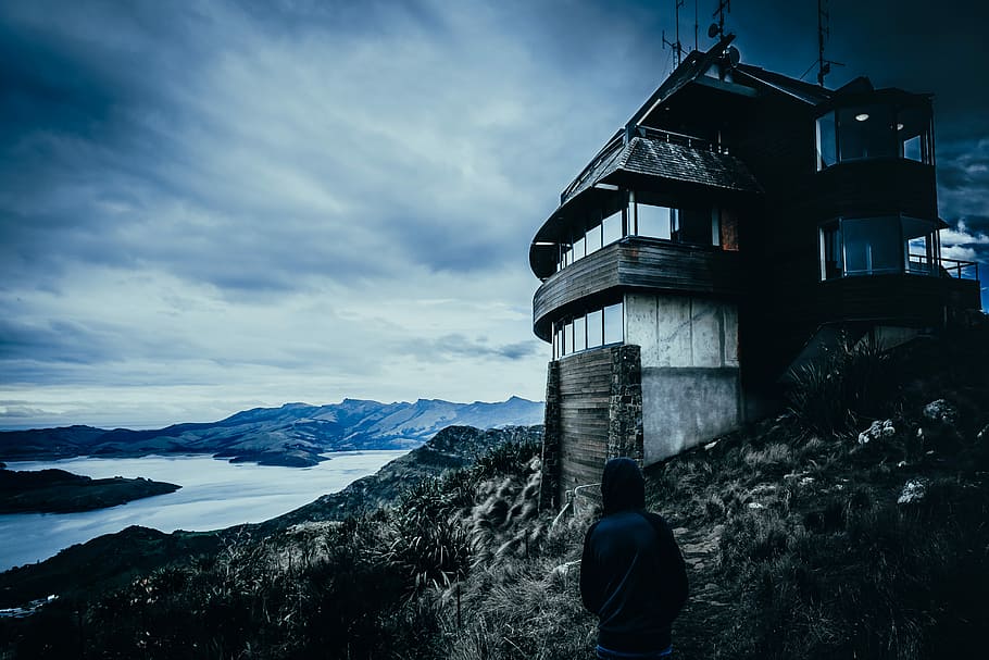 gray concrete house on the rock near body of water photography, gray concrete building on a rock hill HD wallpaper