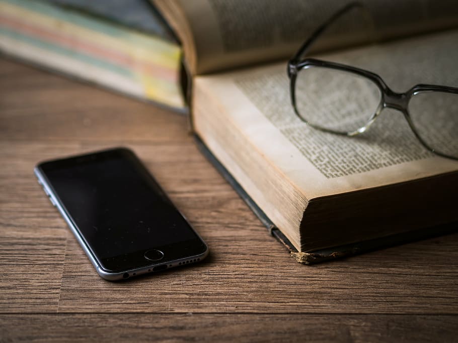 space gray iPhone 6 near eyeglasses and book, screen, technology