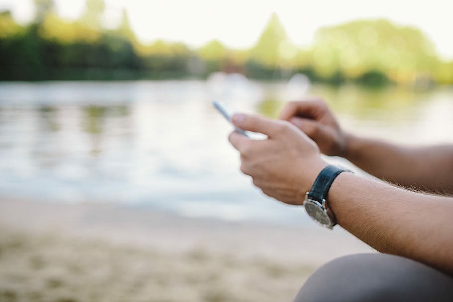 Young Man Using His Phone on beach, people, summer, tech, technology HD wallpaper