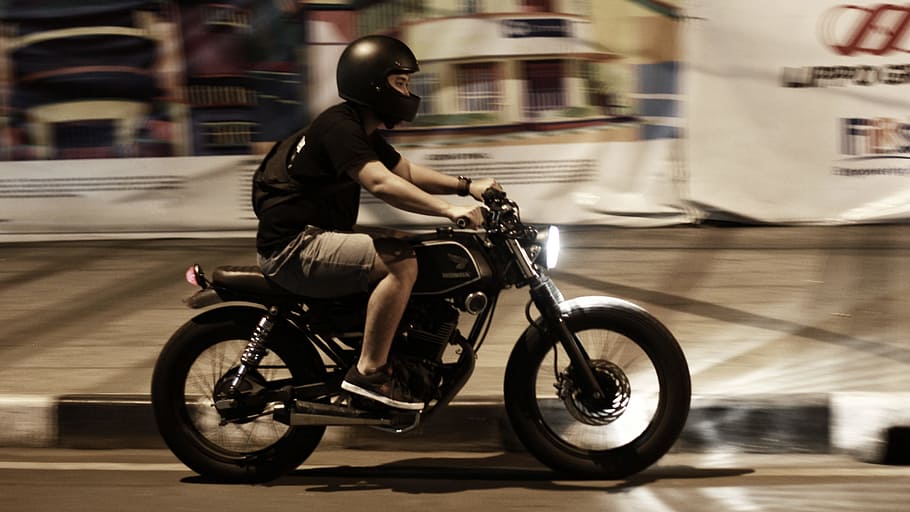 man riding on motorcycle, man ride-on black cruiser motorcycl