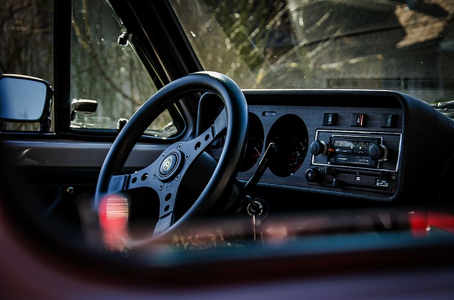 selective focus photography of vehicle steering, black car steering wheel inside a car