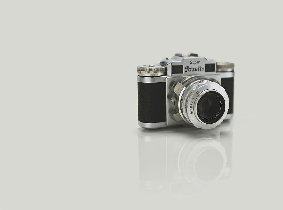 gray and black Super Paxette point-and-shoot camera, gray and black camera on white floor HD wallpaper