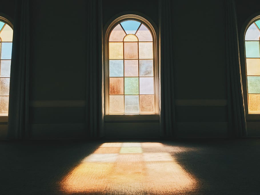 stained glass installed in wall, sun raise through window, church
