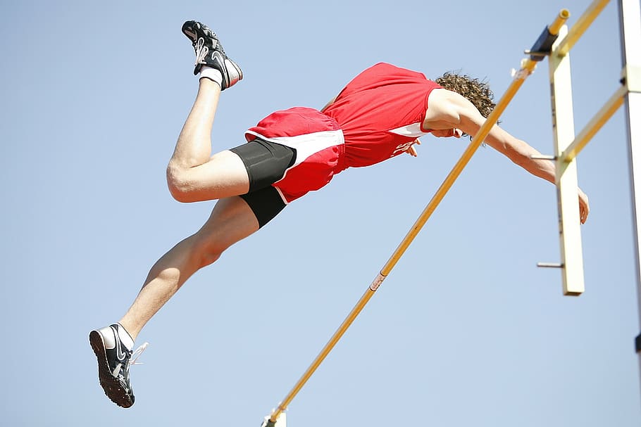 man jumping on a bar, pole vaulter, athlete, competition, sport