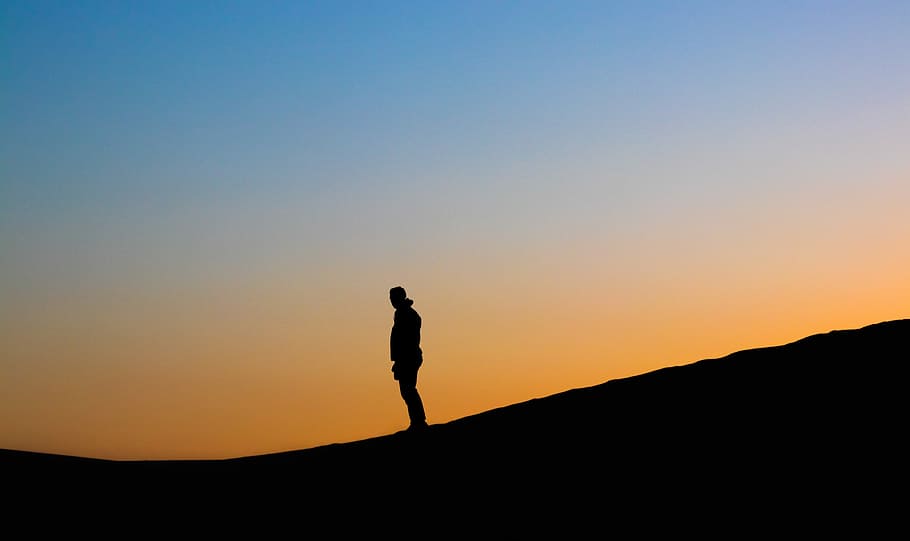 man's silhouette photo during golden hour, silhouette of man standing HD wallpaper