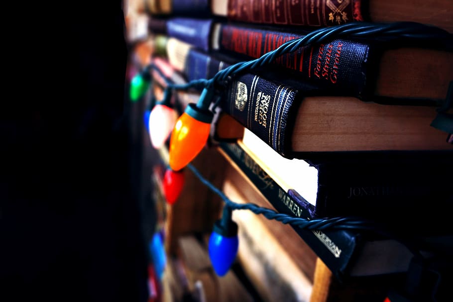 book stack, books, christmas lights, dark, indoors, close-up HD wallpaper