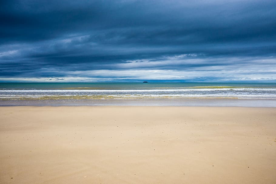 Byron Bay Main Beach, white sand shoreline under cloudy sky, seascape