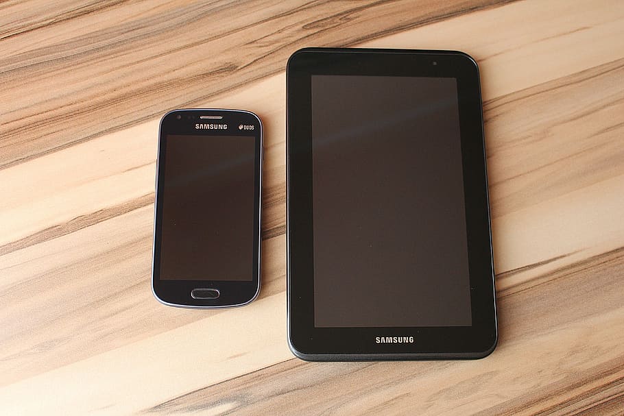 black Samsung Galaxy smartphone near Samsung smart tablet, touch screen HD wallpaper