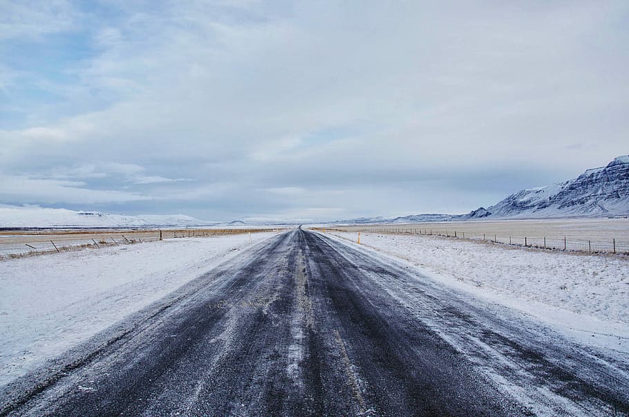 gray asphalt road surrounded by snow, grey road near glacier mountains under blue sky HD wallpaper