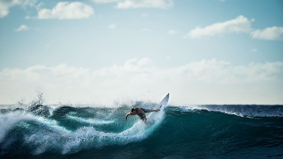 person riding a white surfboard on blue body of water, surfing HD wallpaper