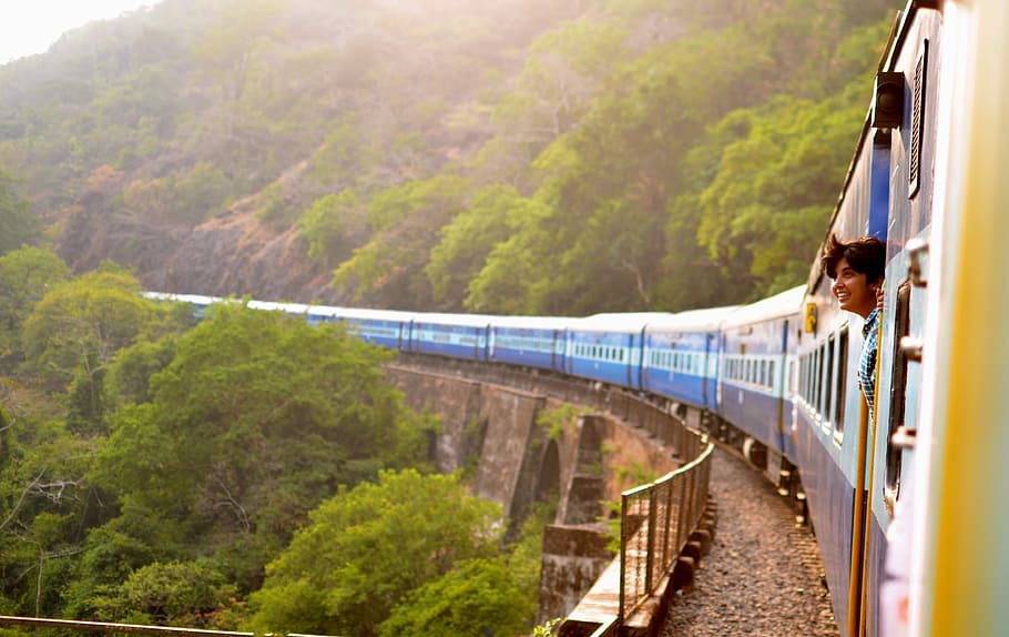 moving train near trees, woman standing on train door, mountain HD wallpaper