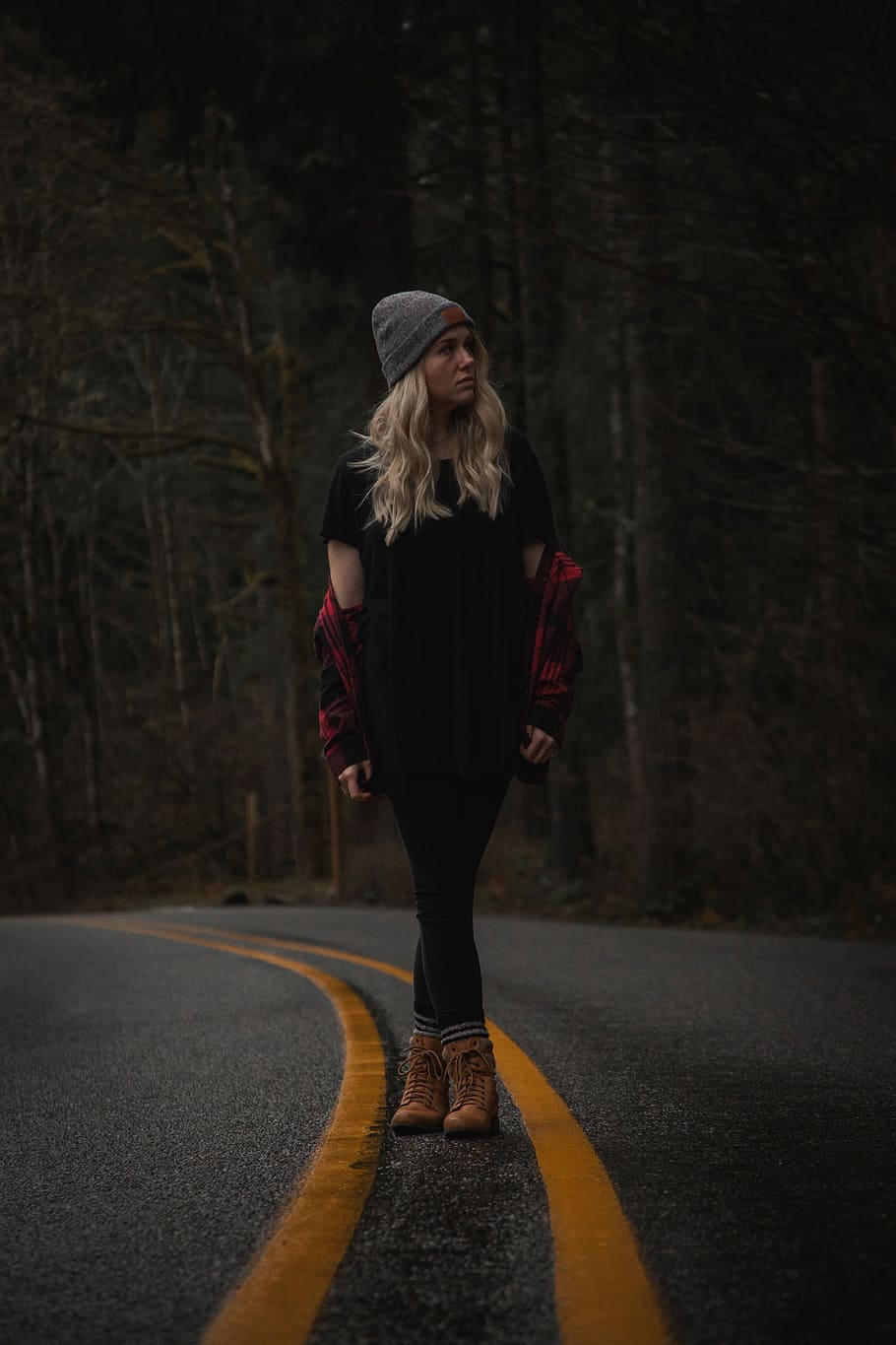 woman standing on road near trees, shallow focus photography of woman standing on forest pathway HD wallpaper