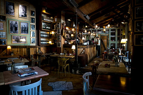 bar interior view, man standing near counter, cafe, restaurant HD wallpaper