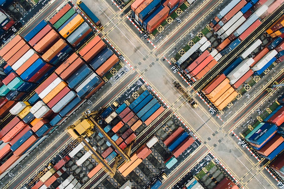 bird's-eye view of piled intermodal containers on concrete ground HD wallpaper