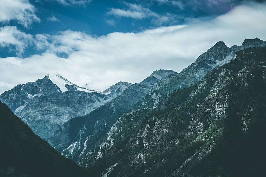 aerial shot of mountains, white snowy mountain under blue and white cloudy sky during daytime HD wallpaper