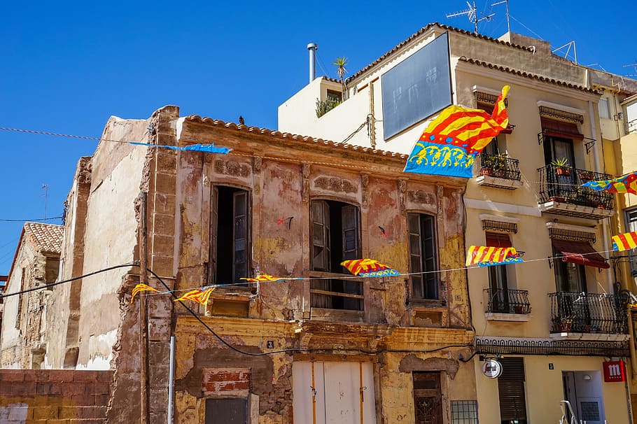 Flags in Valencia., beige concrete house under blue sky, building HD wallpaper
