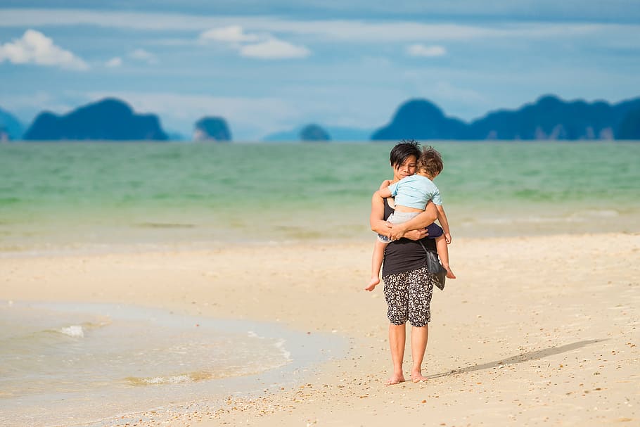 woman carrying baby on sea shore, mom, son, tropical, beach, child
