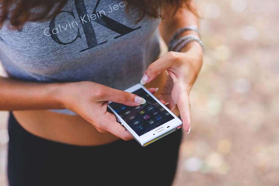 Smartphone in girl's hands, Calvin Klein, cell phone, mobile, HD wallpaper