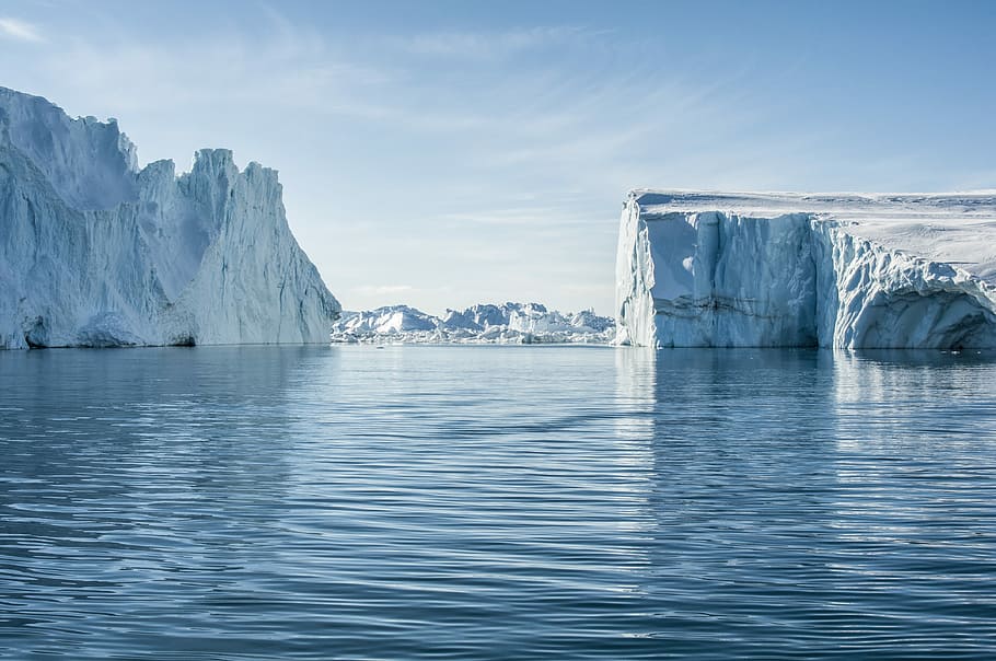 icebergs on body of water under blue and white sky at daytime, body of water near white mountains under blue sky at daytime HD wallpaper