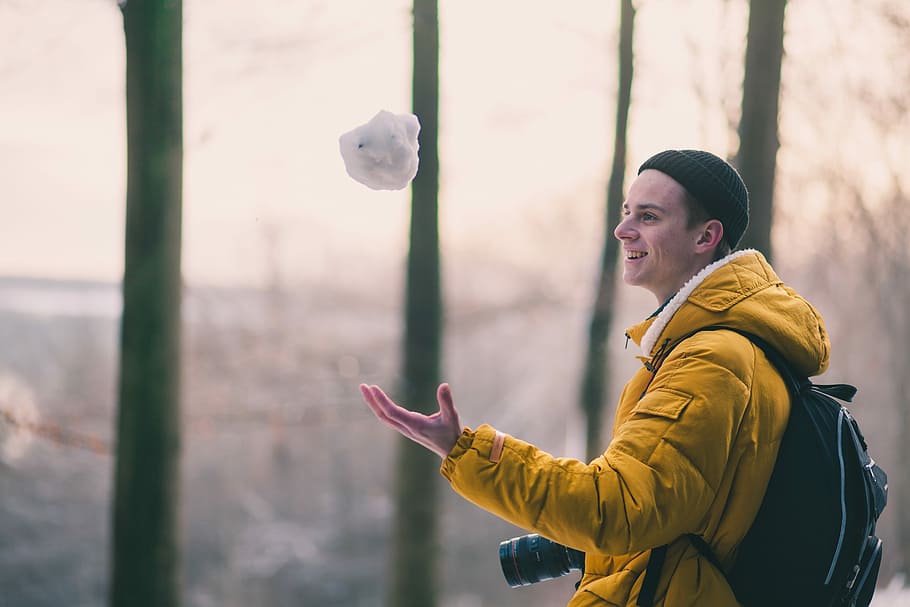 selective focus photo of man catching snowball, photo of man making snowball HD wallpaper