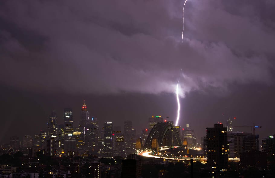 thunder on concrete buildings, aerial photography of city at night time HD wallpaper