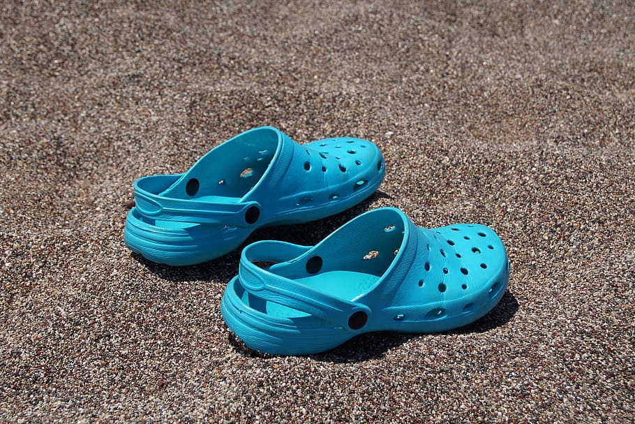 teal Crocs Classic clogs on brown surface, beach, pebbles, boots, HD wallpaper