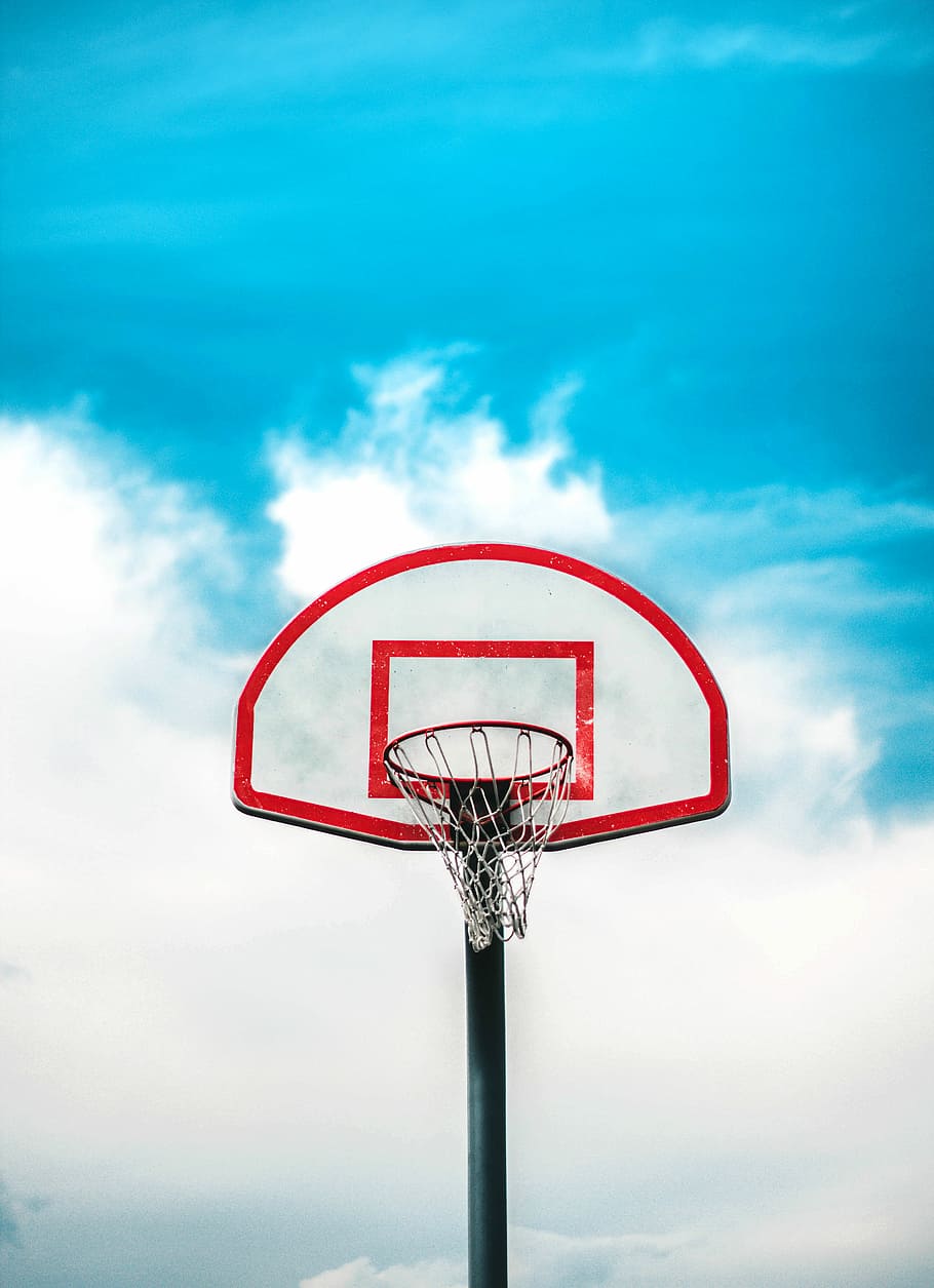 red and black basketball hoop under cloudy sky, basketball hoop and ring under white and blue sunny cloudy sky