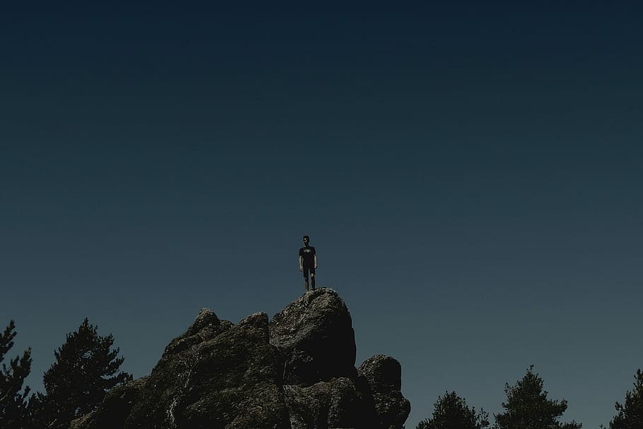 At the top, man standing on gray rock, rocks, sky, dark, lanscape HD wallpaper
