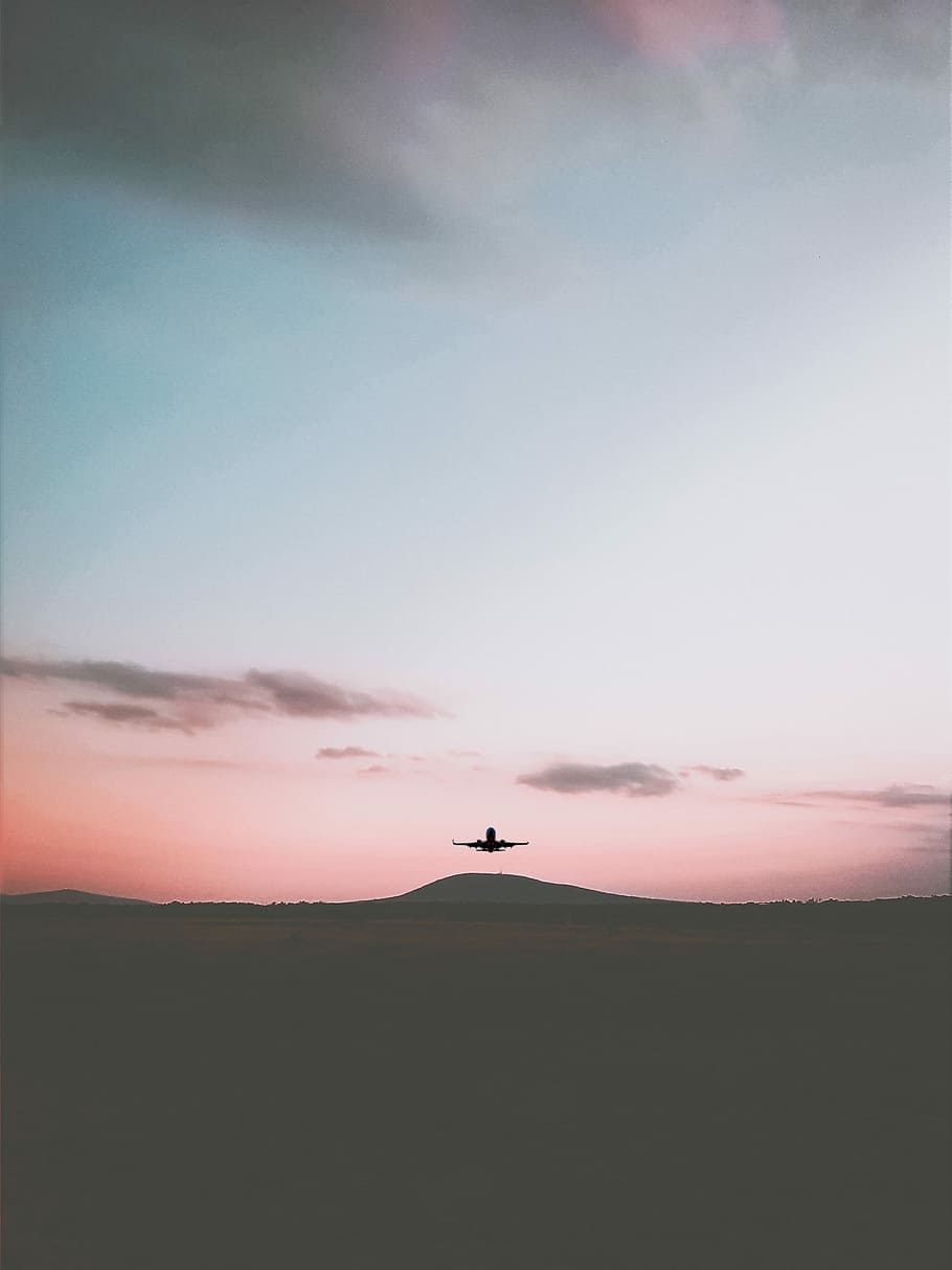 silhouette of airplane flying under cloudy sky during daytime, black airplane flying on sky near mountain during daytime HD wallpaper