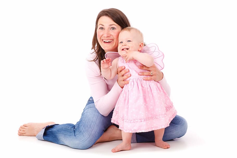woman in pink long-sleeved top and blue jeans sitting on floor with infant in pink dress, HD wallpaper