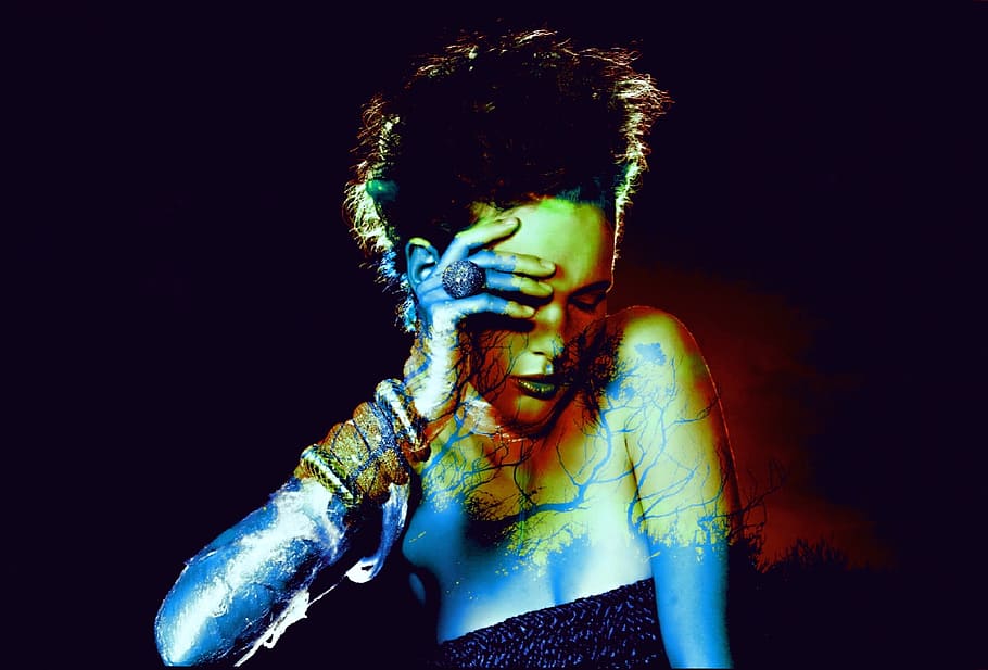photo of woman holding fourhead, people, dark, performance HD wallpaper