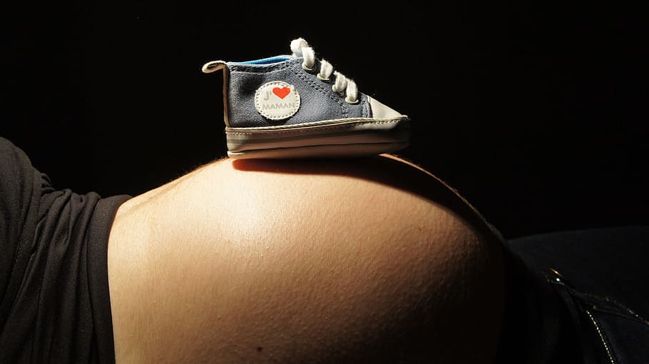 unpaired baby's blue high-top crib shoe on woman's belly, Speaker, HD wallpaper