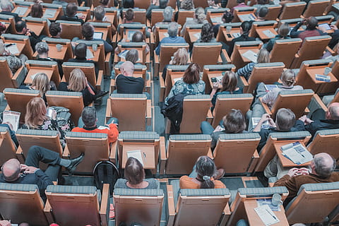 high-angle photography of group of people sitting at chairs, people studying inside a room HD wallpaper