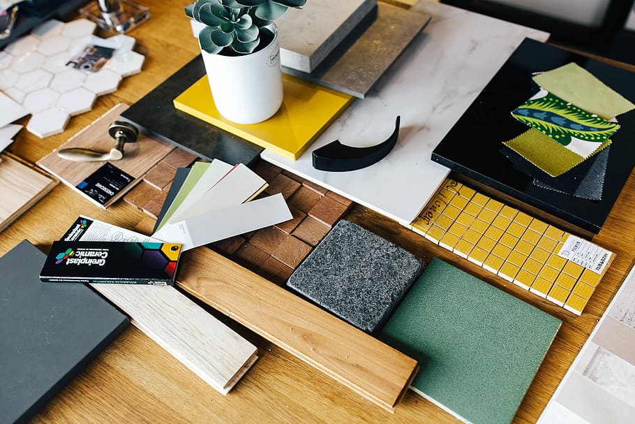 Designers working with material samples and paper cutouts, fabric HD wallpaper