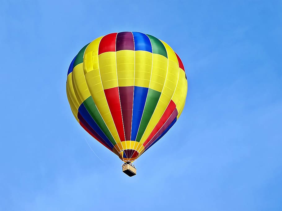 yellow and multicolored hot air balloon flying in the sky during daytime HD wallpaper