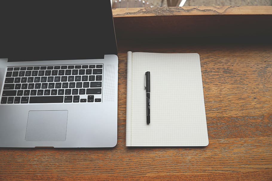 pen on notebook beside MacBook on table, pro, brown, line, paper HD wallpaper