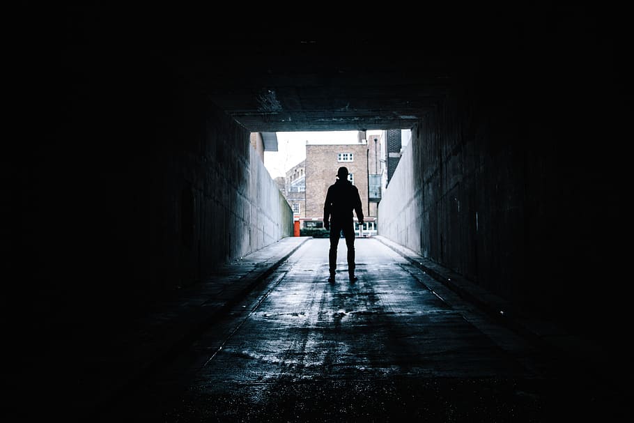 silhouette of man in underground garage, silhouette of a person standing in a parking entrance during day time HD wallpaper