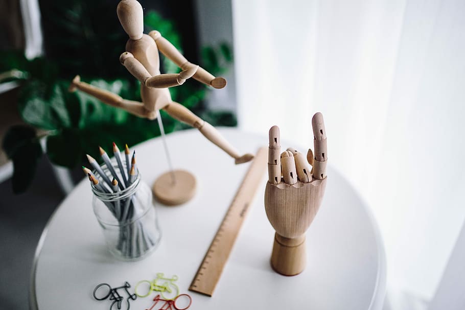 Wooden mannequin in various poses, hand, model, yarn, pencils