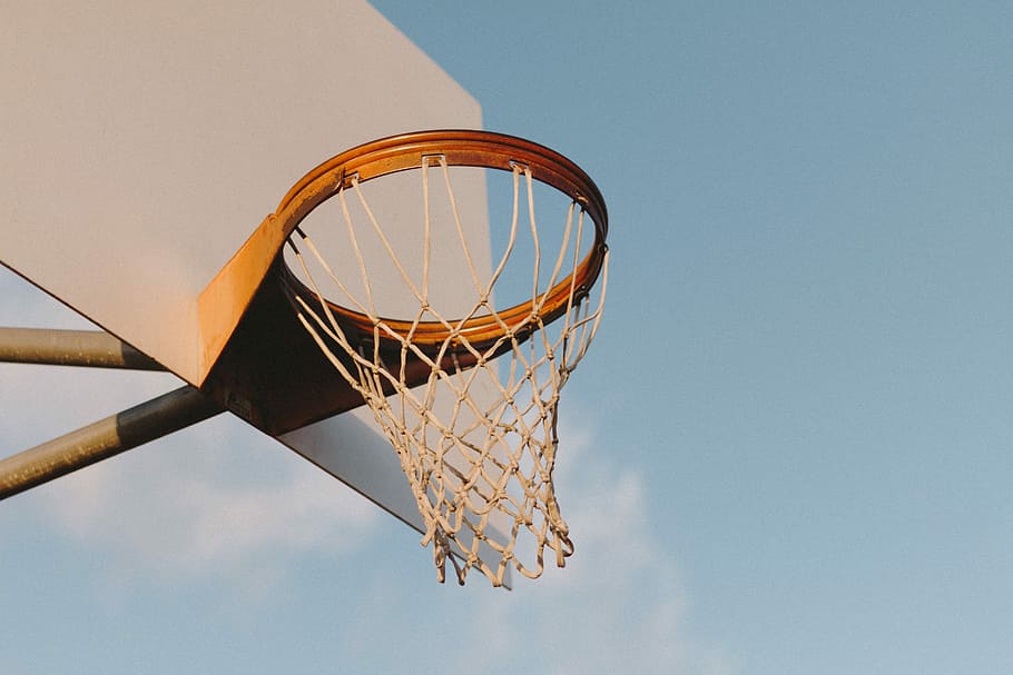 low angle photography of basketball hoop, brown and white outdoor basketball system