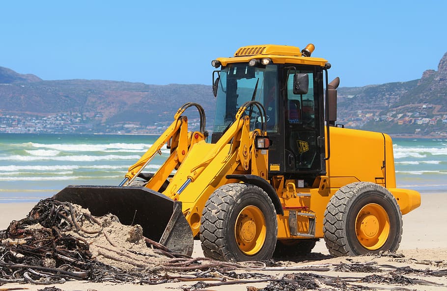 yellow front loader near shoreline, sea, beach, excavators, cleaning