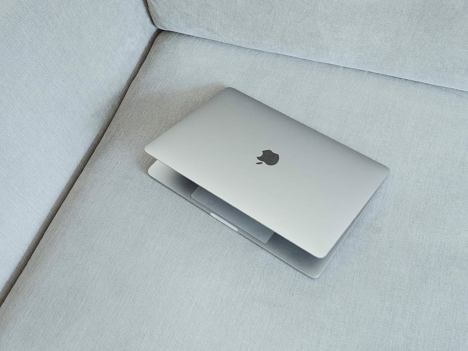 silver MacBook on white fabric sofa, silver MacBook on gray fabric sofa HD wallpaper