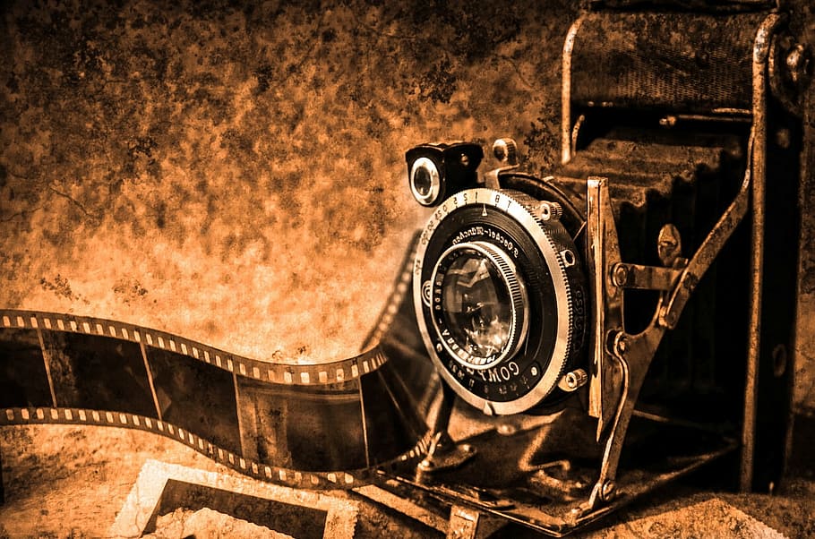 black folding camera on brown surface, photo camera, photography