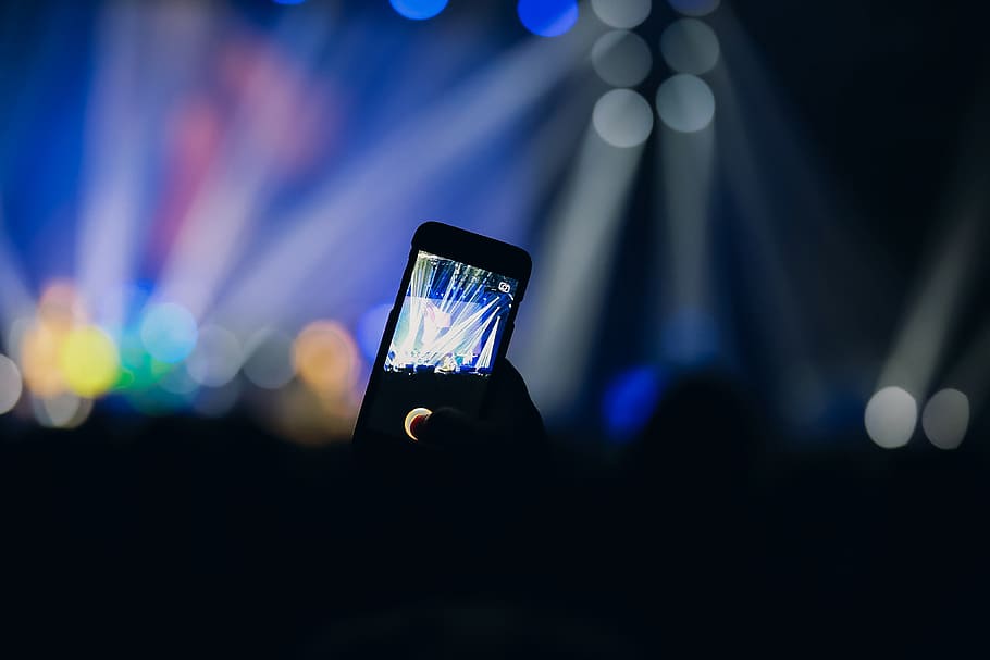 A person uses the camera in the crowd on his mobile smartphone at a music concert party event, HD wallpaper