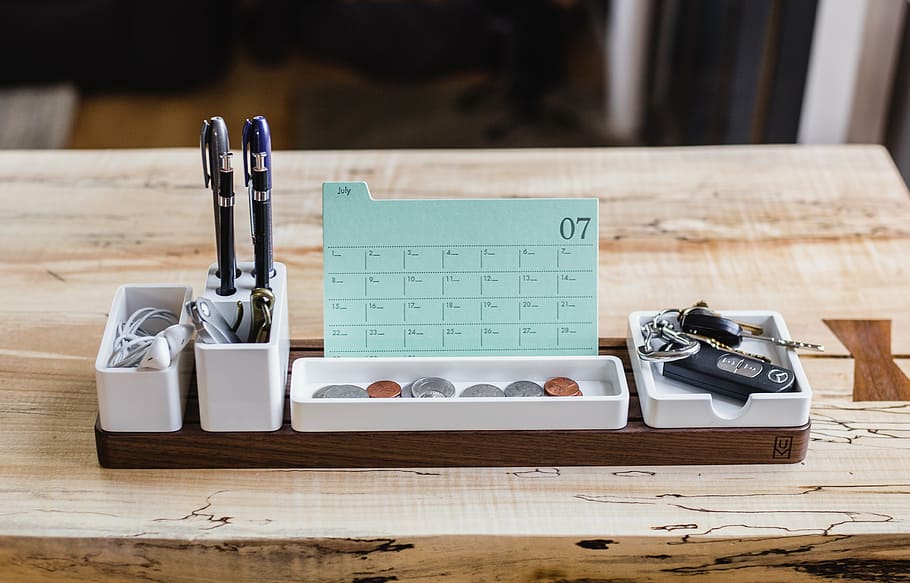 pens, coins, and keys on ceramic table organizer, calendar HD wallpaper