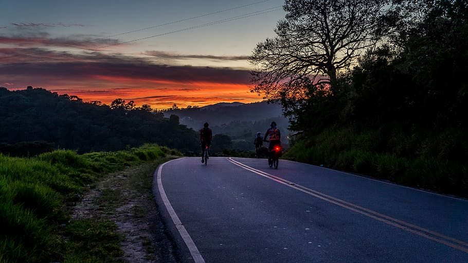 two people riding bicycle on gray concrete road during daytime HD wallpaper