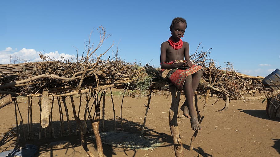 child sitting on brown roof, Ethiopia, Tribe, Africa, Culture