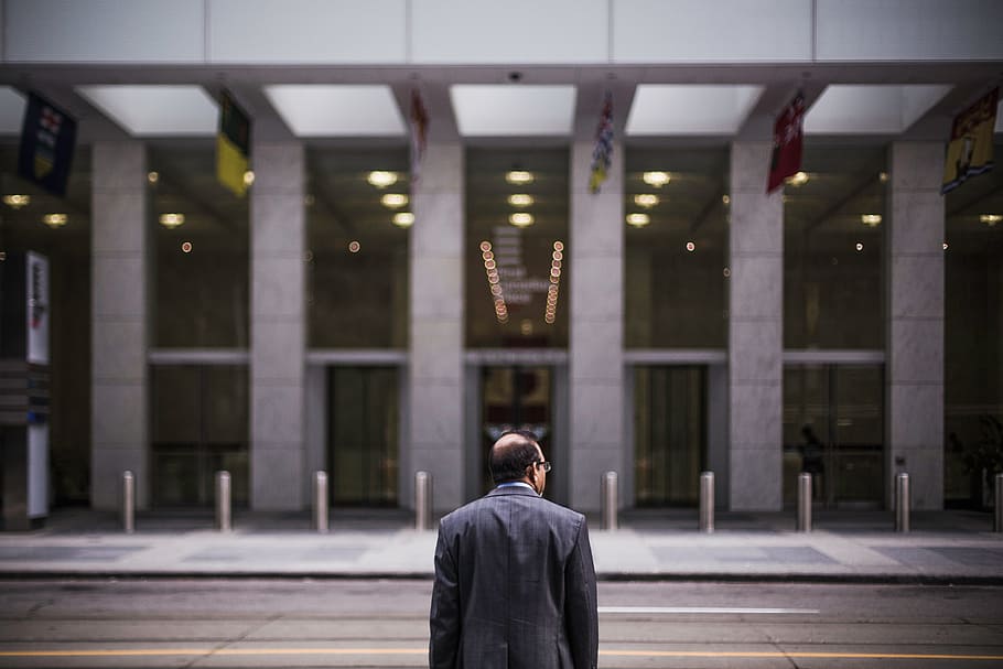 man in black coat in building, person, front, columns, business HD wallpaper